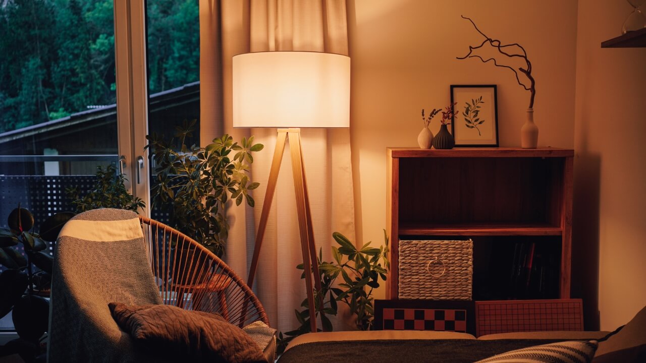 warm lighting, bed side corner, and a cozy ambience